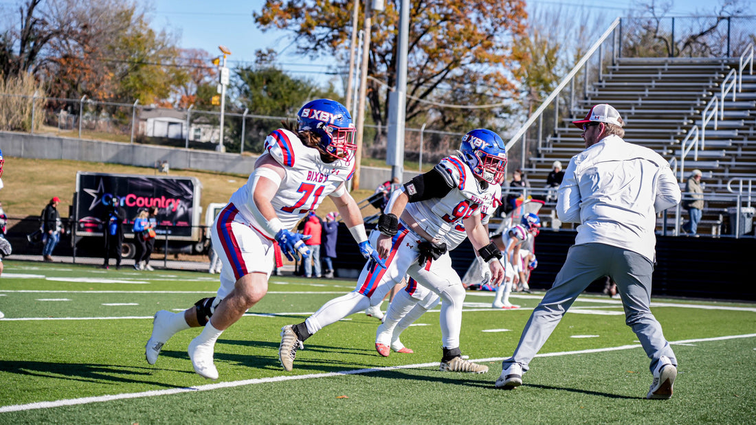 Bixby Spartans players warming up on the field