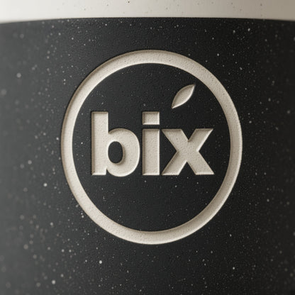 Close-up of lowercase bix badge engraved through black speckled glaze