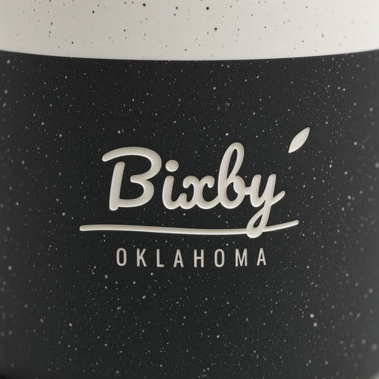 Close-up of Bixby Oklahoma script engraved through black speckled glaze